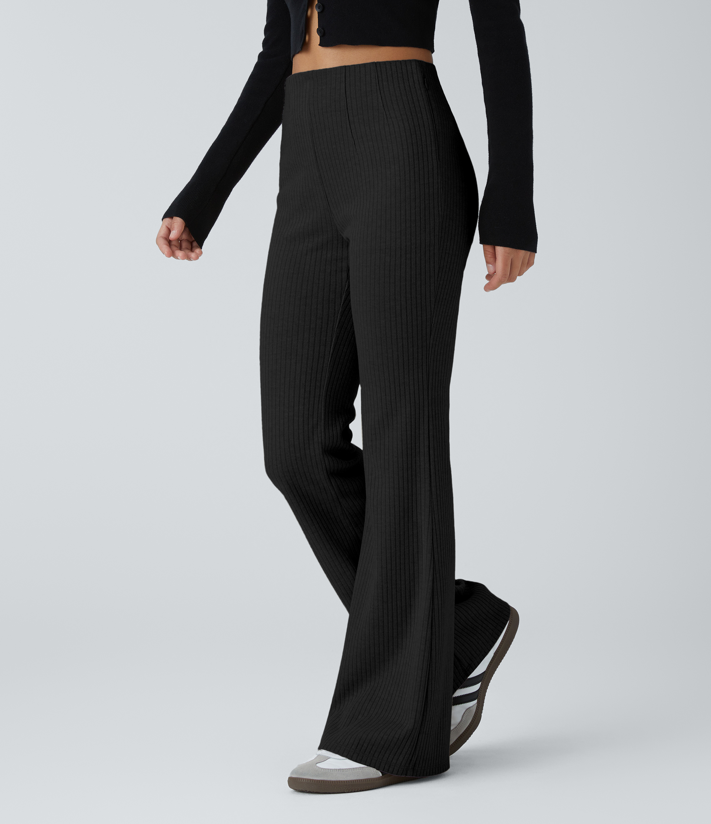 Black Casual ribbed-knit flared pants with a high waistband and side zip pockets. / 1