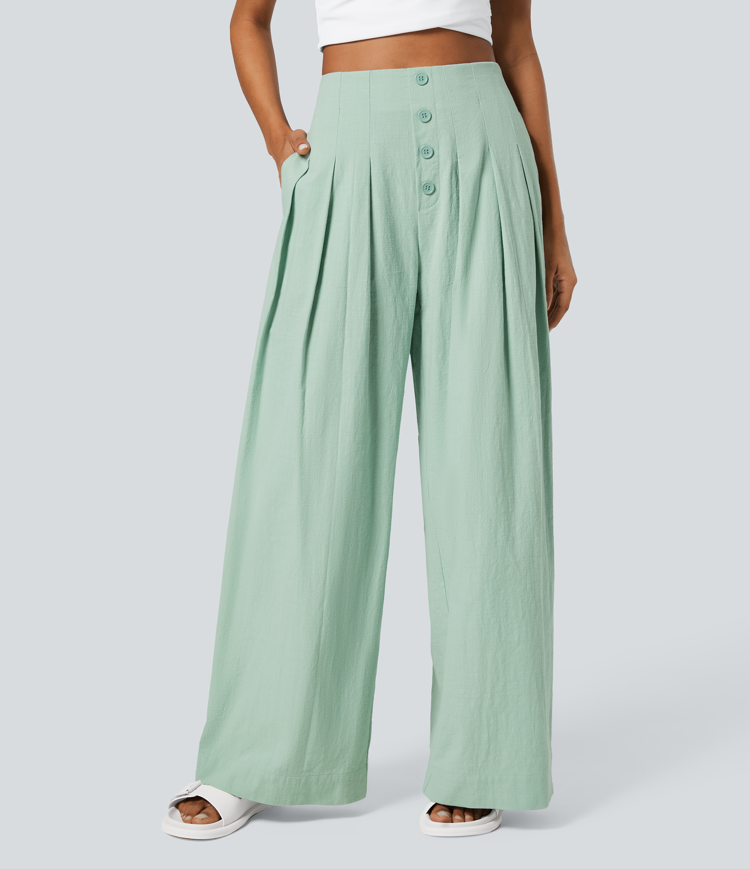 Casual high-waisted cotton pants with buttoned side pockets and a wide leg.