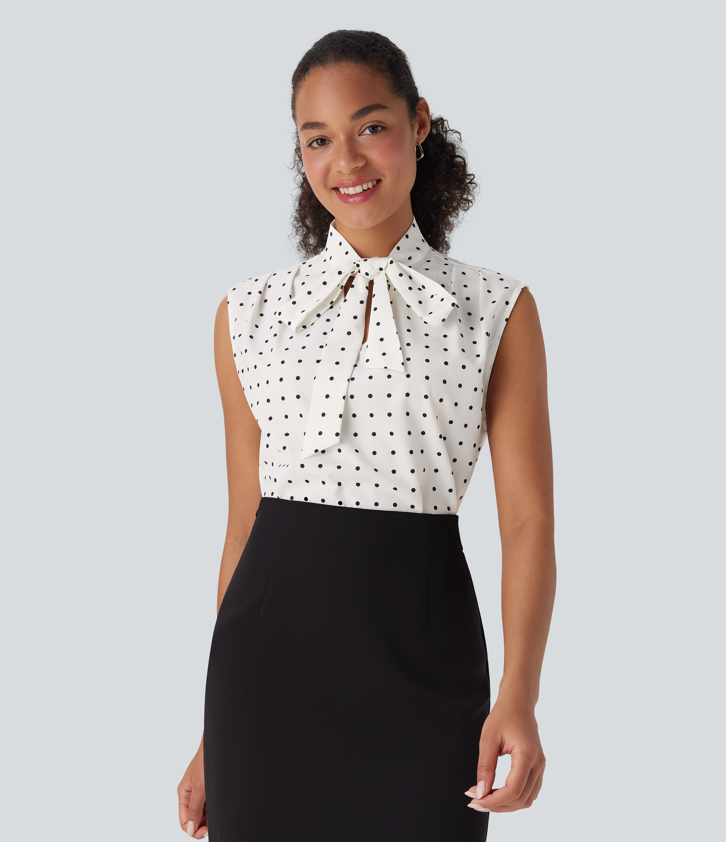 Camisa de oficina sin mangas con lunares y lazo en la parte delantera 