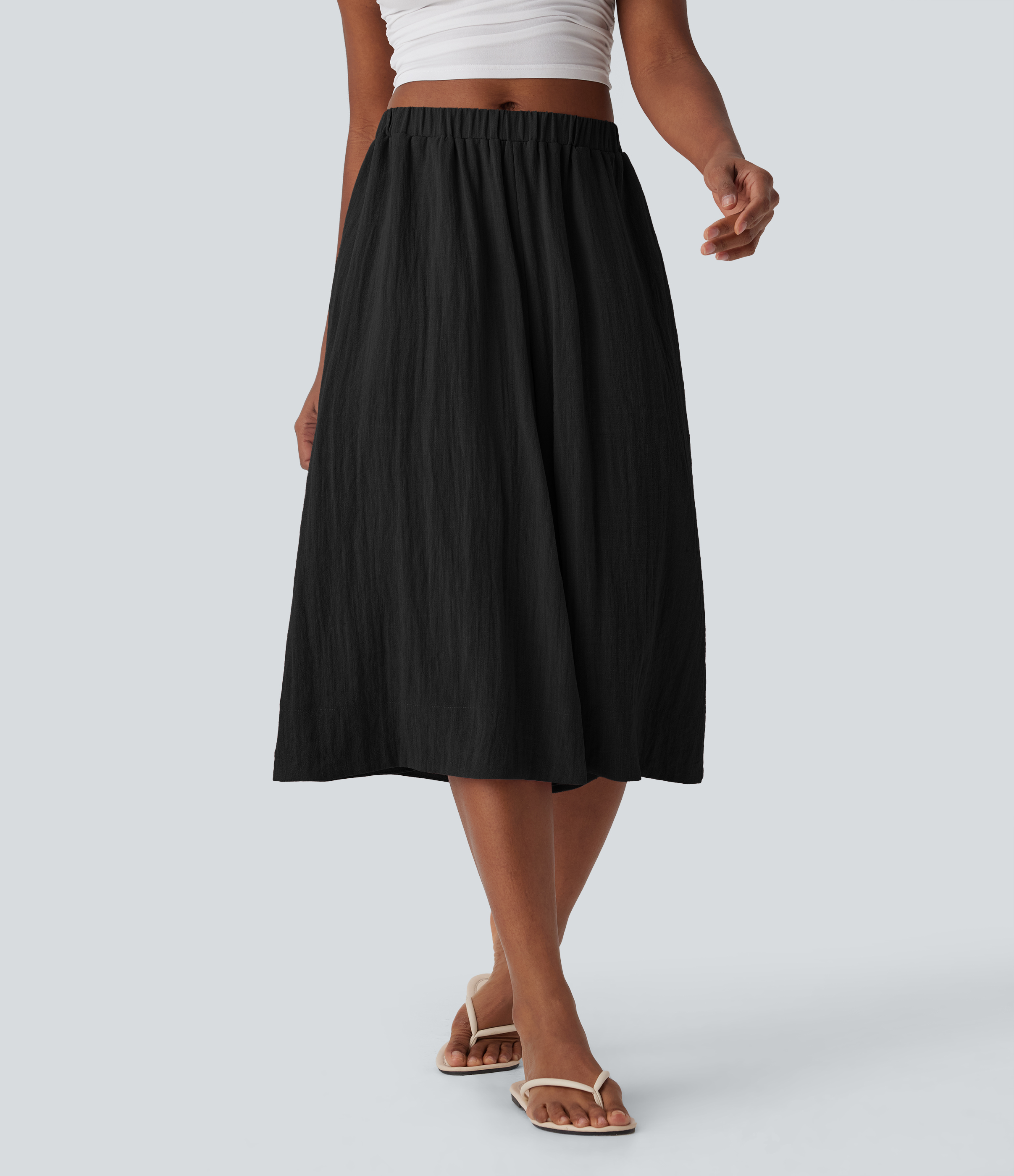 Pantalones de lino anchos y fluidos de tiro medio con bolsillos laterales