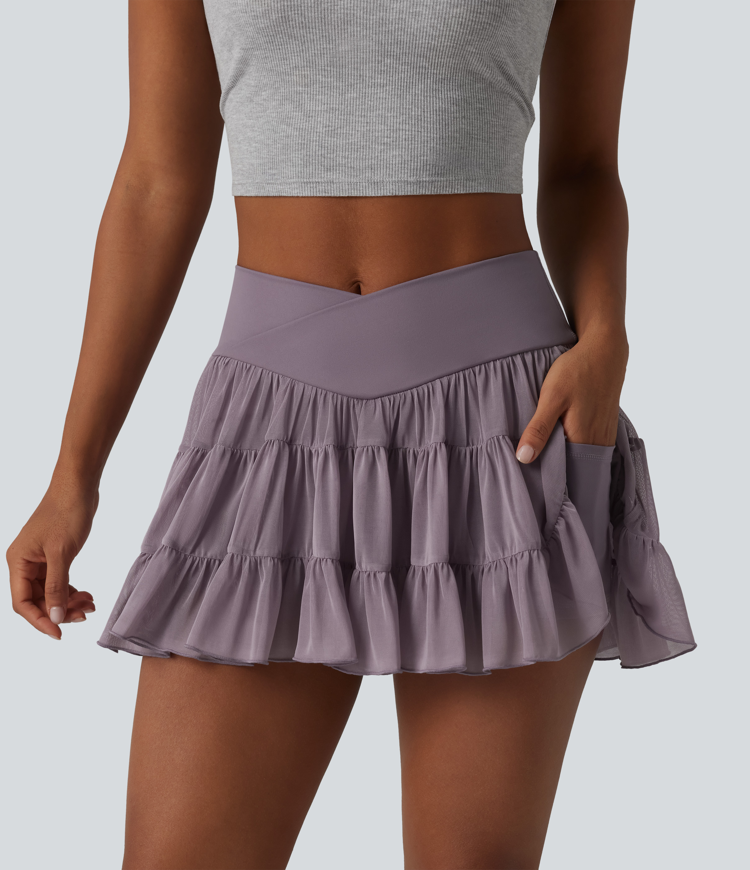 Flowing 2-in-1 tennis mini skirt with high crossover waistband, side pockets and crisscrossed straps - shorter length